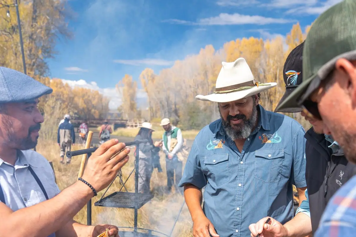 Josh Crumpton hosting an outdoor wild game cook over an open fire