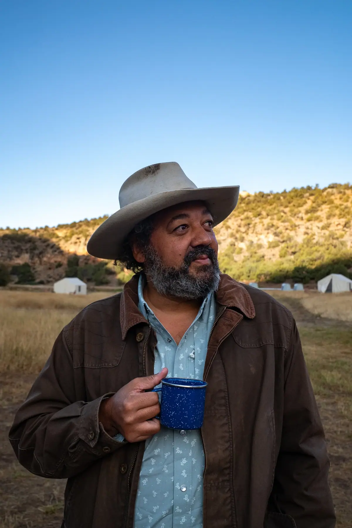 Josh Crumpton with a morning coffee at camp, Paintrock Canyon Ranch, Wyoming